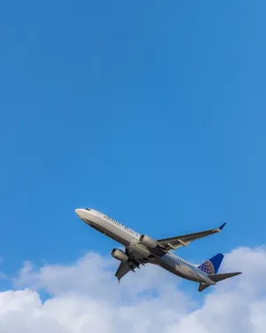 Flying White And Blue Airplane Android Wallpaper