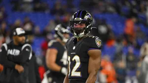 Focused Football Playeron Field Wallpaper