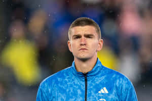 Focused Soccer Playerin Blue Adidas Jacket Wallpaper