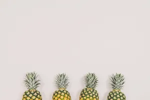 Four Pineapples On White Background Wallpaper
