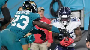 Foyesade Oluokun Tackling Opponent During Game Wallpaper