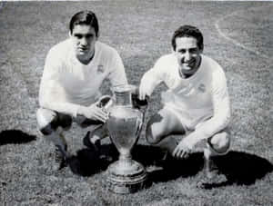 Francisco Gento Posing Next To A Trophy Wallpaper
