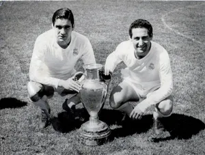 Francisco Gento Posing Next To A Trophy Wallpaper