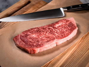 Fresh Kobe Beef Wagyu On Brown Paper Wallpaper