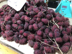Fresh Pulasan Fruits On Sale Wallpaper