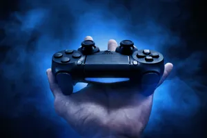 Gaming Controller On Hand Wallpaper
