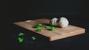 Garlic Vegetable Herb With Leaves On Chopping Board Wallpaper