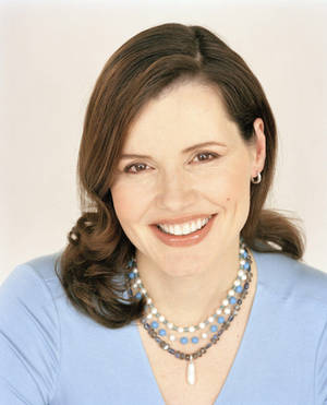 Geena Davis Glowing In Baby Blue Top Wallpaper