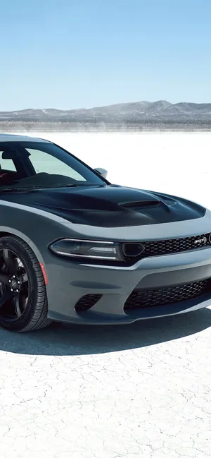 Get Behind The Wheel Of The Iconic Dodge Charger With This Bold Iphone Wallpaper. Wallpaper
