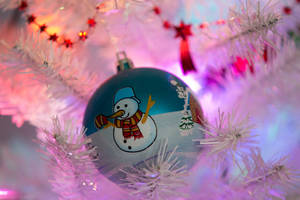 Get Festive With This Snowman Wearing Christmas Lights Wallpaper
