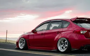 Get Ready For An Adrenaline Rush With This Red Jdm Car As It Zooms Through The Desert Road. Wallpaper