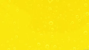 Get Your Work Done In Style With A Pastel Yellow Laptop Wallpaper