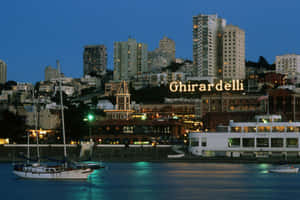 Ghiradelli Square By Ocean With Boats Wallpaper