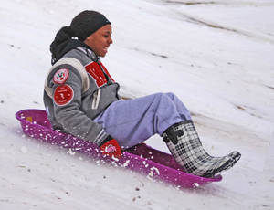 Girl Smiling Sledding Wallpaper