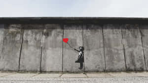 Girl With Balloon In Berlin Wall Wallpaper