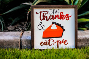 Give Thanks And Eat Pie Poster With Brown Frame On Green Grass Field Wallpaper
