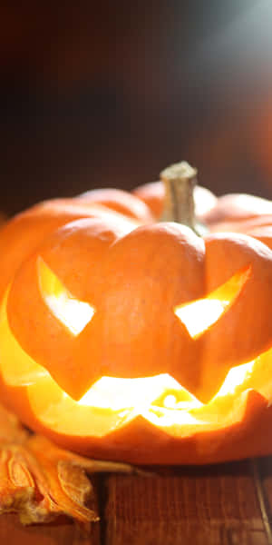Glowing Halloween Pumpkin Vertical Wallpaper