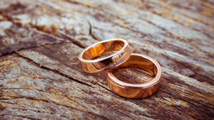 Gold Wedding Rings On Wood Wallpaper