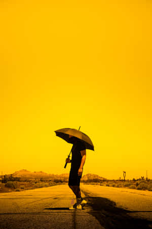 Golden Hued Desert Umbrella Walk Wallpaper