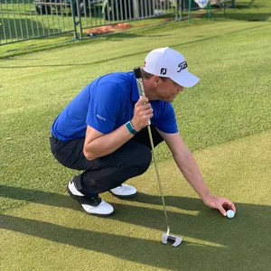 Golfer Analyzing Putton Green Wallpaper