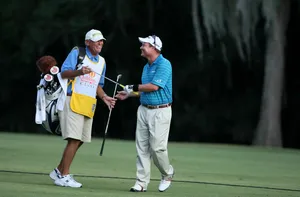 Golferand Caddie Laughing Together Wallpaper