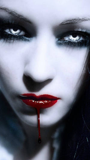 Gothic Vampire Girl’s Intense Stare Wallpaper