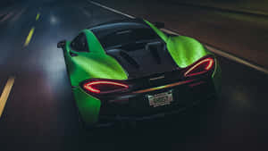 Green Sports Car Speeding Night Wallpaper