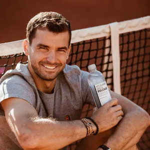 Grigor Dimitrov Smiling With Water Bottle Wallpaper