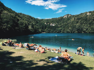 Group Of People By The Lake Wallpaper