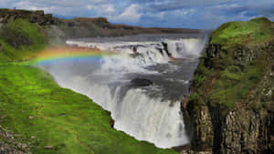 Gullfoss Waterfall Peak With Rainbow In Southwest Iceland Wallpaper