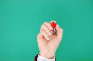 Hand Holding Red Permanent Marker Wallpaper