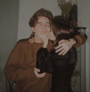 Happy Couple Enjoying A Cozy Embrace Wallpaper