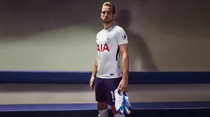 Harry Kane Holding Shoes Wallpaper