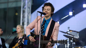 Harry Styles Using His Laptop Wallpaper