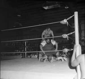 Haystacks Calhoun Facing Off Against Three Wrestlers In A 1963 Match At Fairgrounds Expo Wallpaper