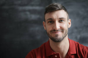 Headshot Of A Man In Red Wallpaper