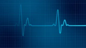 Healthcare Professional Monitoring An Electrocardiogram Wallpaper