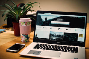 High-end Dell Laptop On A Table Wallpaper