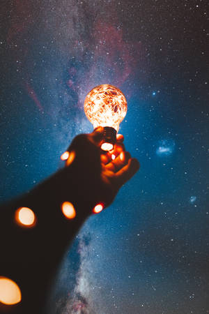 High Resolution Star Hand Holding Light Bulb Wallpaper