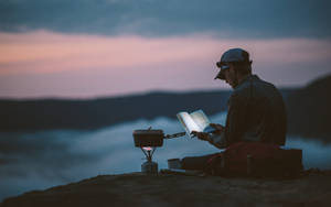 Hiker Reading Book In Mountain Wallpaper
