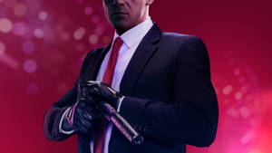 Hitman Full 4k Racking A Gun Wallpaper