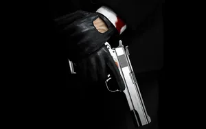 Hitman Hand Holding His Handgun Wallpaper