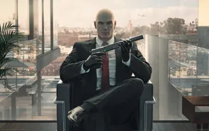 Hitman Sitting On Chair Wallpaper
