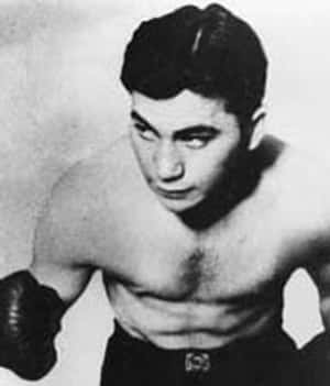 Hollywood Action Star Barney Ross Kicking Ass In The Expendables Wallpaper