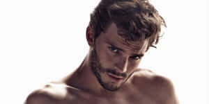 Hollywood Star Jamie Dornan In A Relaxed Pose Wallpaper