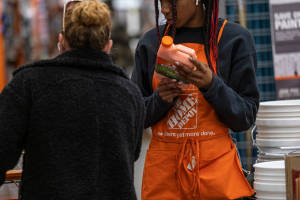 Home Depot Employee Assisting Customer In Store Wallpaper