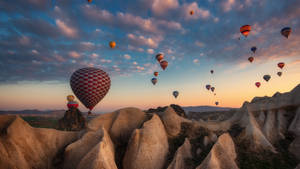 Hot Air Balloon Over Rock Mountains Wallpaper