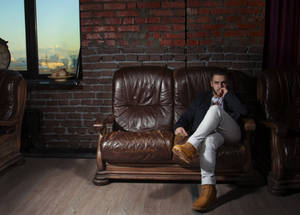 Hot Guy On Brown Couch Wallpaper