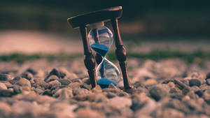 Hourglass On Rocks Tiempo Background Wallpaper