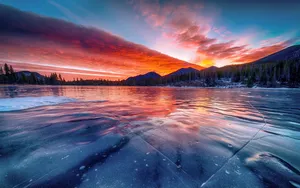 Icy Lake With Mountains Sunset Wallpaper